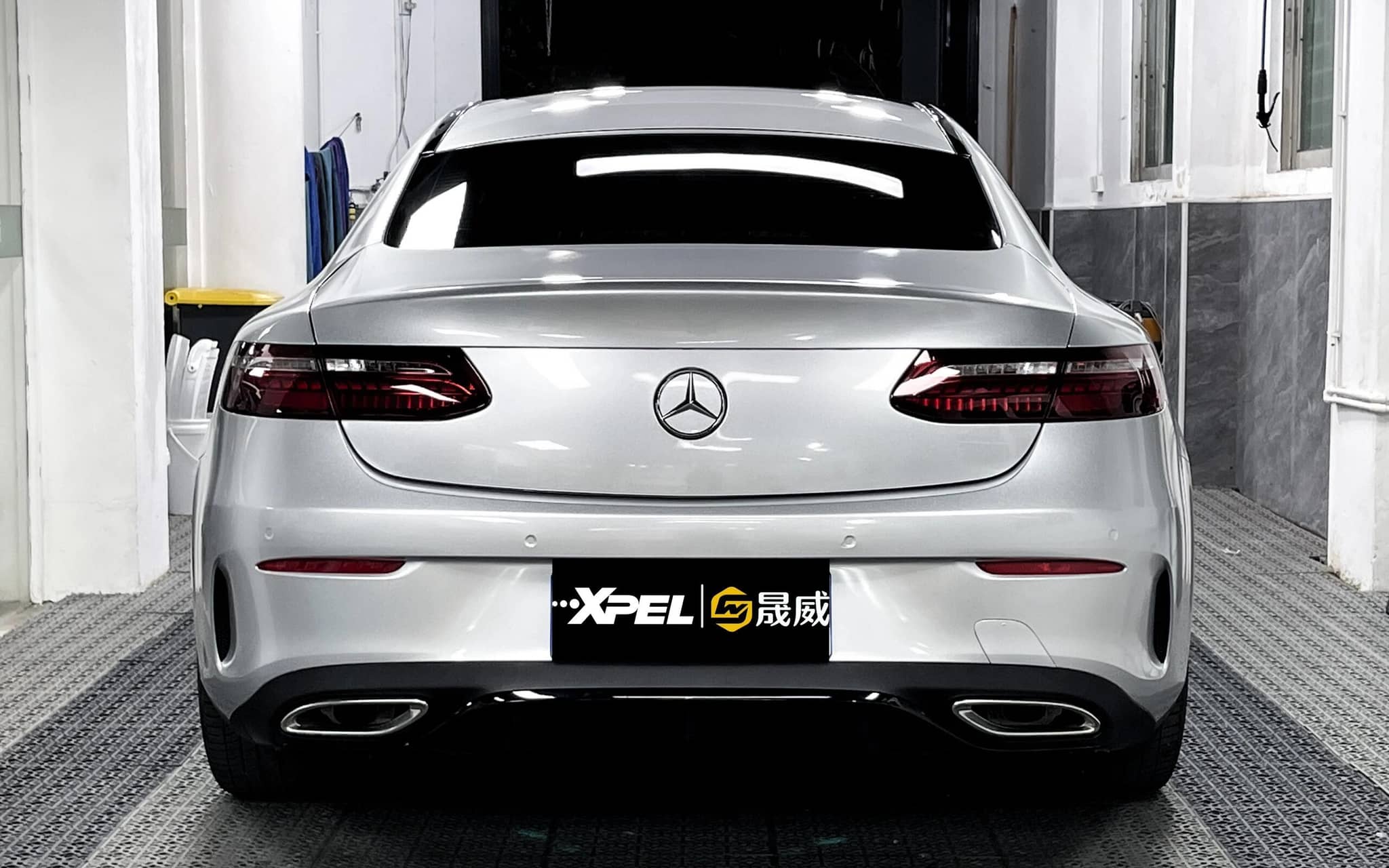 Silver Mercedes car shown from rear in garage without Pre-cut Tesla Vinyl Wrap Kit