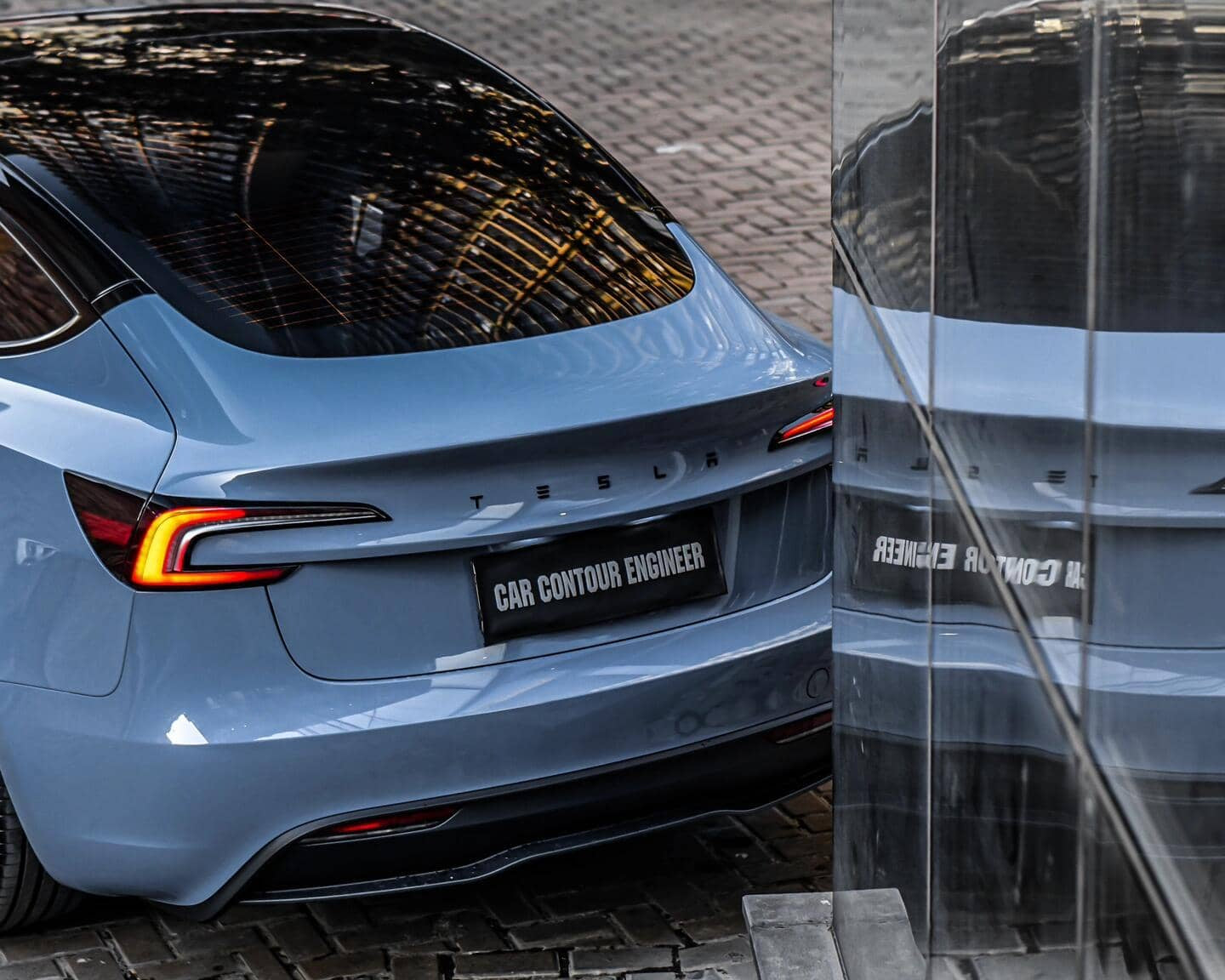 Rear view of blue Tesla wrapped with a glossy Pre-cut Tesla Vinyl Wrap Kit by WrapBug