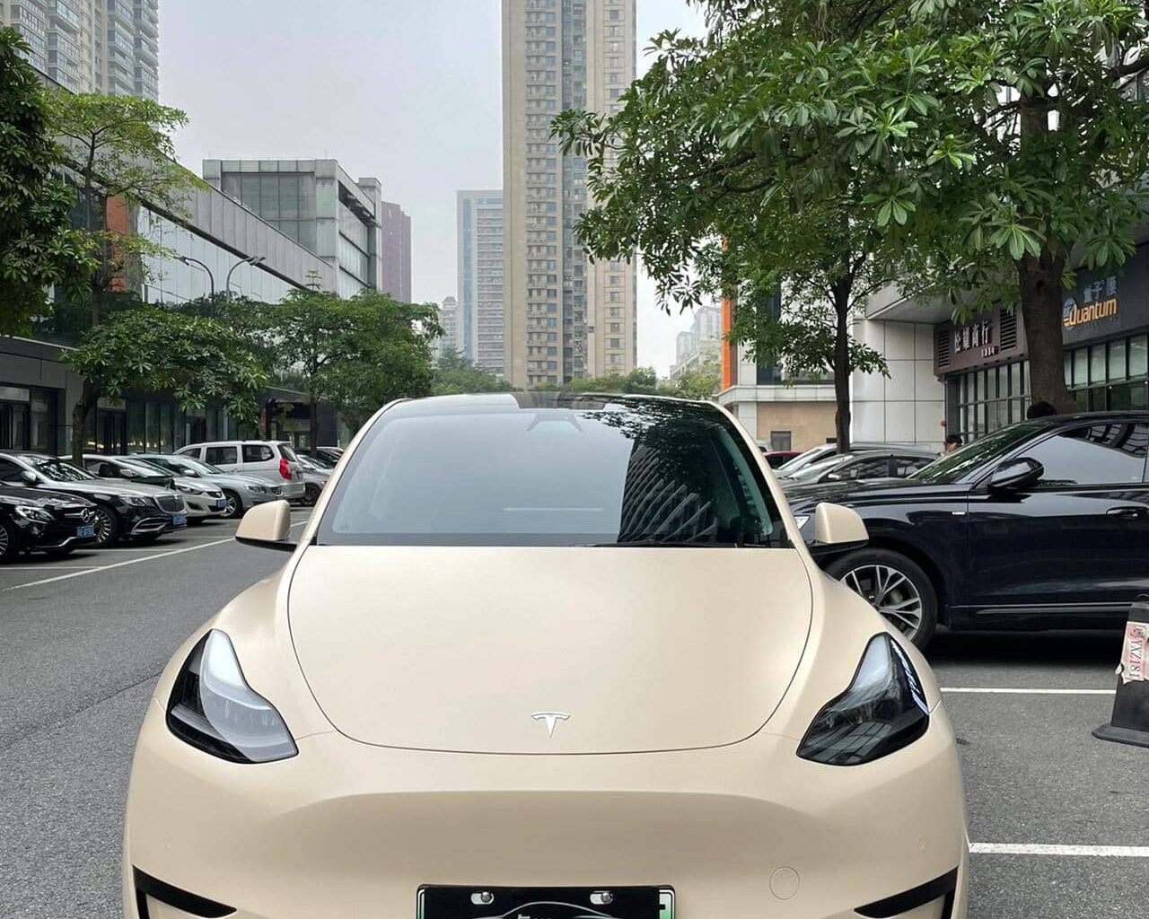 Front view of Tesla car with matte MATTE SPACE GRAY tesla wrap parked on city street