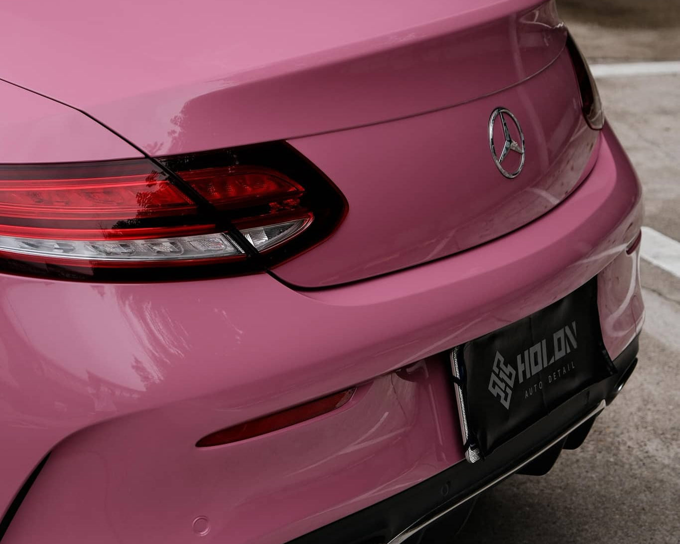 WrapBug Pre-cut Tesla Wrap Kit applied on the rear of a pink luxury car in an outdoor setting