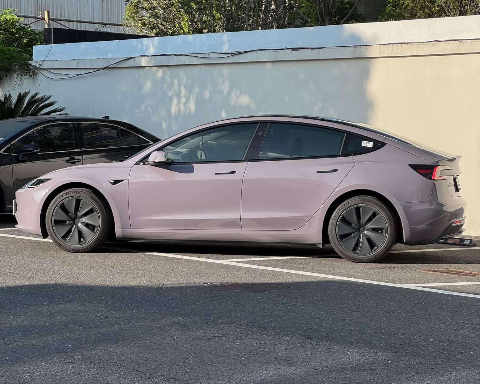 Tesla Model 3 parked with light purple wrap applied using Pre-cut Tesla Wrap Kit by WrapBug