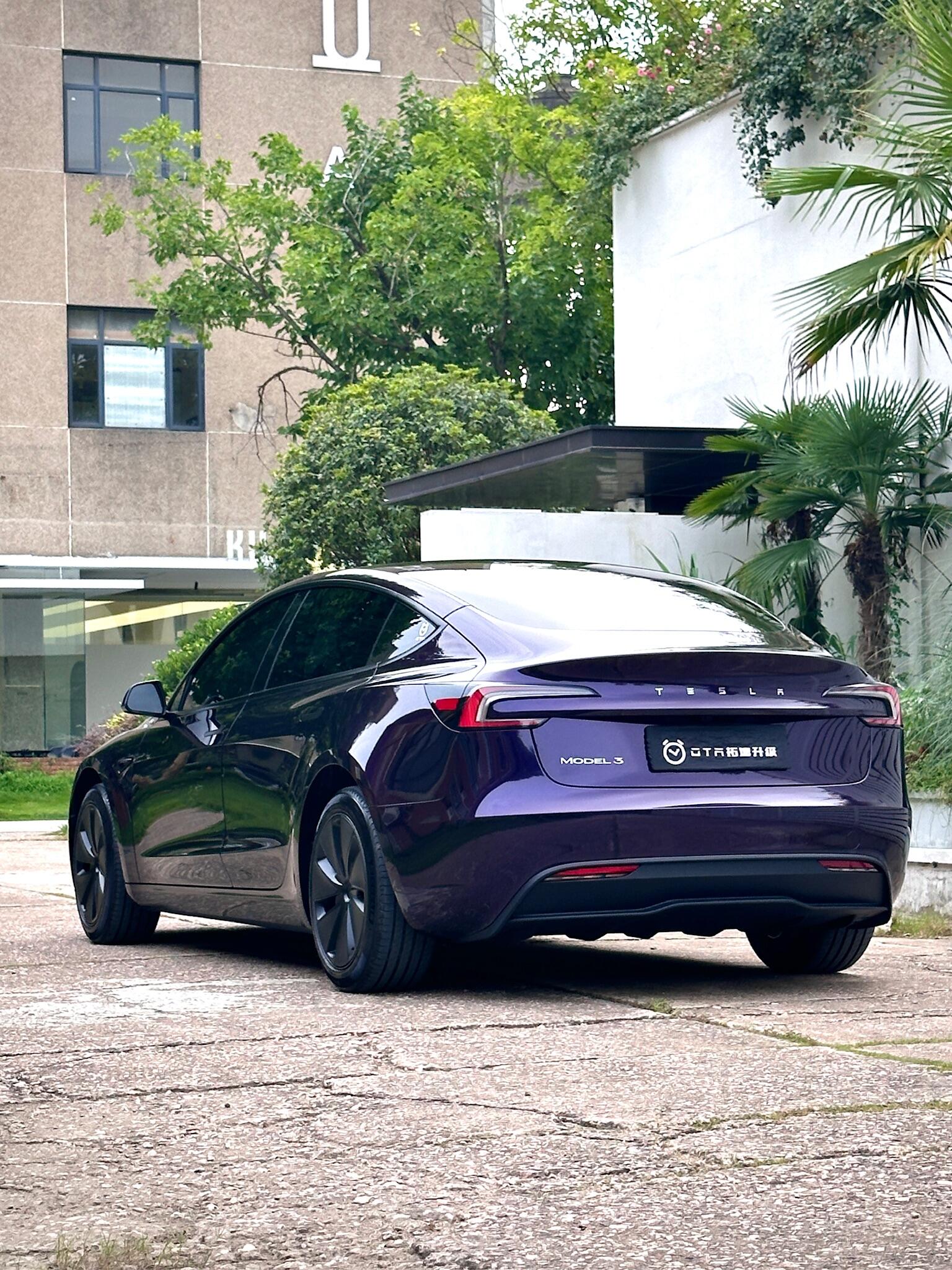 Purple Tesla Model 3 parked outdoors showcasing a smooth finish with a Pre-cut Tesla Wrap Kit from WrapBug
