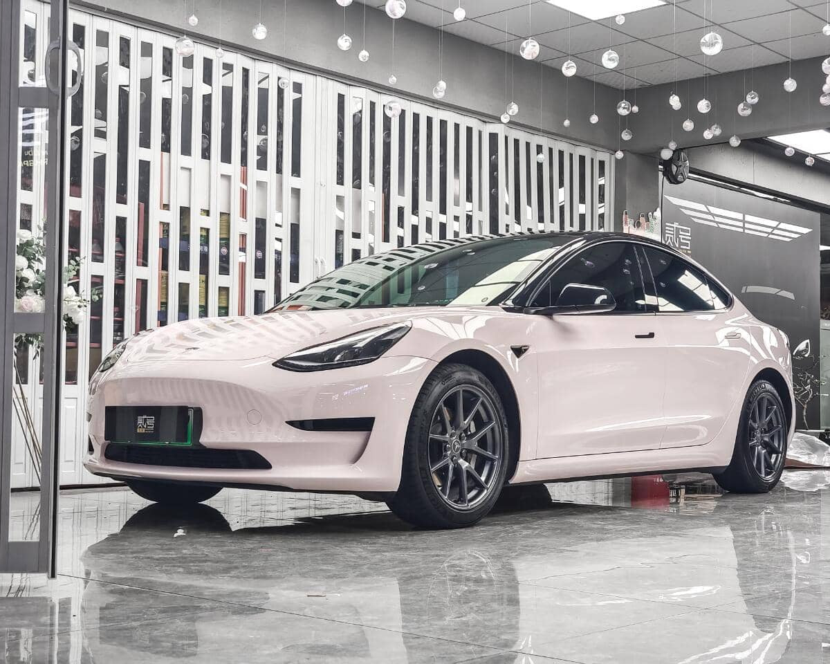 White Tesla Model 3 wrapped with a Pre-cut Tesla Wrap Kit by WrapBug in a showroom