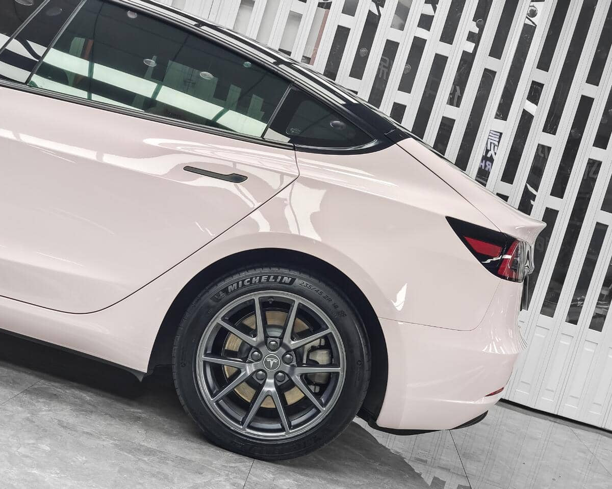 WrapBug Pre-cut Tesla Wrap Kit applied on rear side of white Tesla Model 3 with black roof and alloy wheels