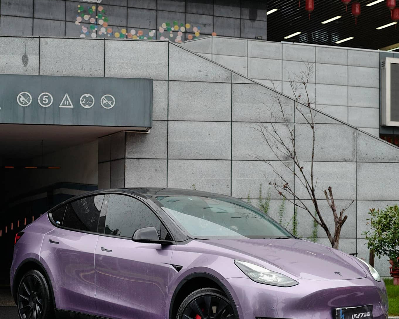 Purple Tesla Model Y parked outdoors with WrapBug Pre-cut Tesla Wrap Kit applied for sleek appearance