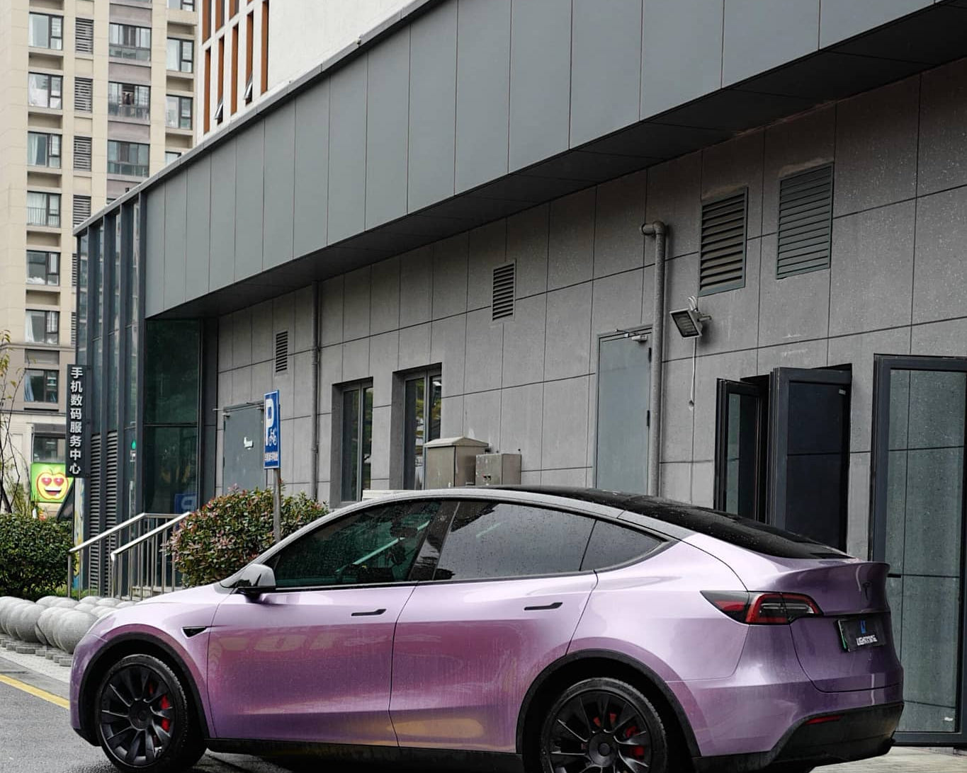 Purple Tesla Model Y wrapped with a Pre-cut Tesla Wrap Kit parked on city street near modern building