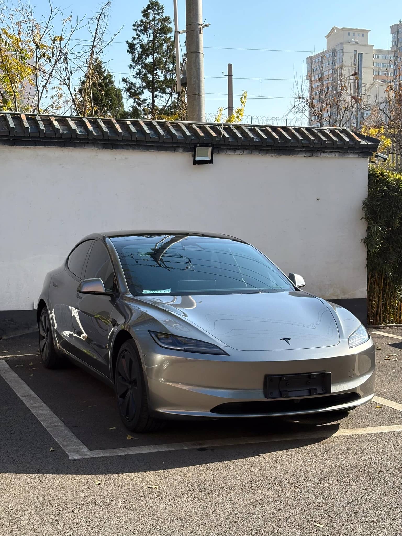 Silver Tesla parked outdoors showcasing smooth finish ideal for Pre-cut Tesla Wrap Kit application