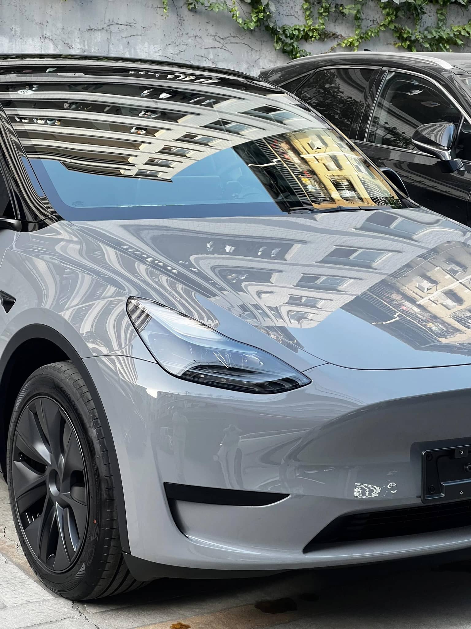 Front view of a silver Tesla car featuring glossy tesla color PPF paint protection film