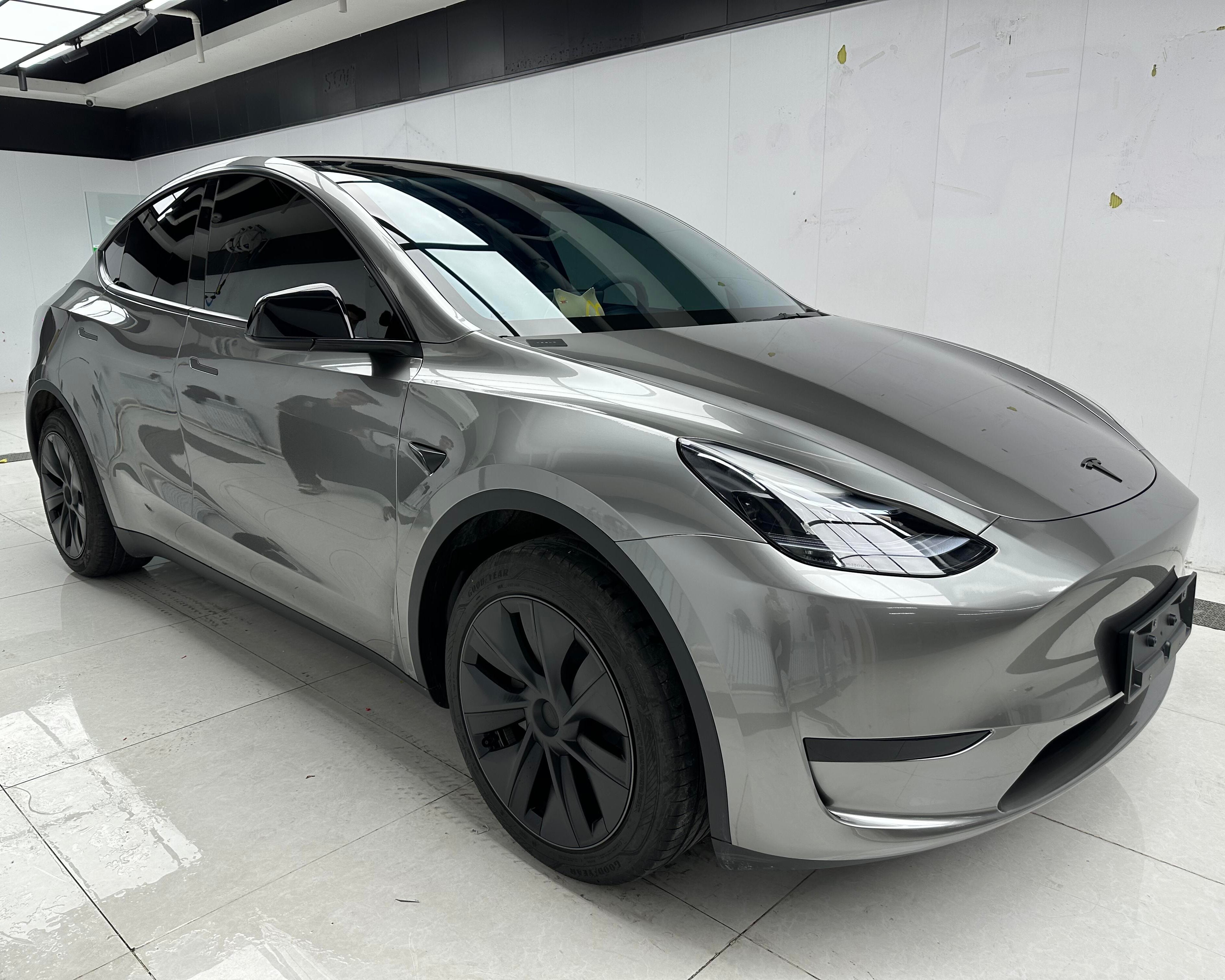 Tesla Model Y with gray glossy finish installed using Pre-cut Tesla Wrap Kit by WrapBug