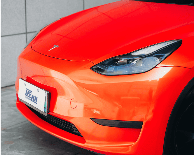 Red Tesla Model 3 front end wrapped with a Pre-cut Tesla Wrap Kit by WrapBug in a glossy finish