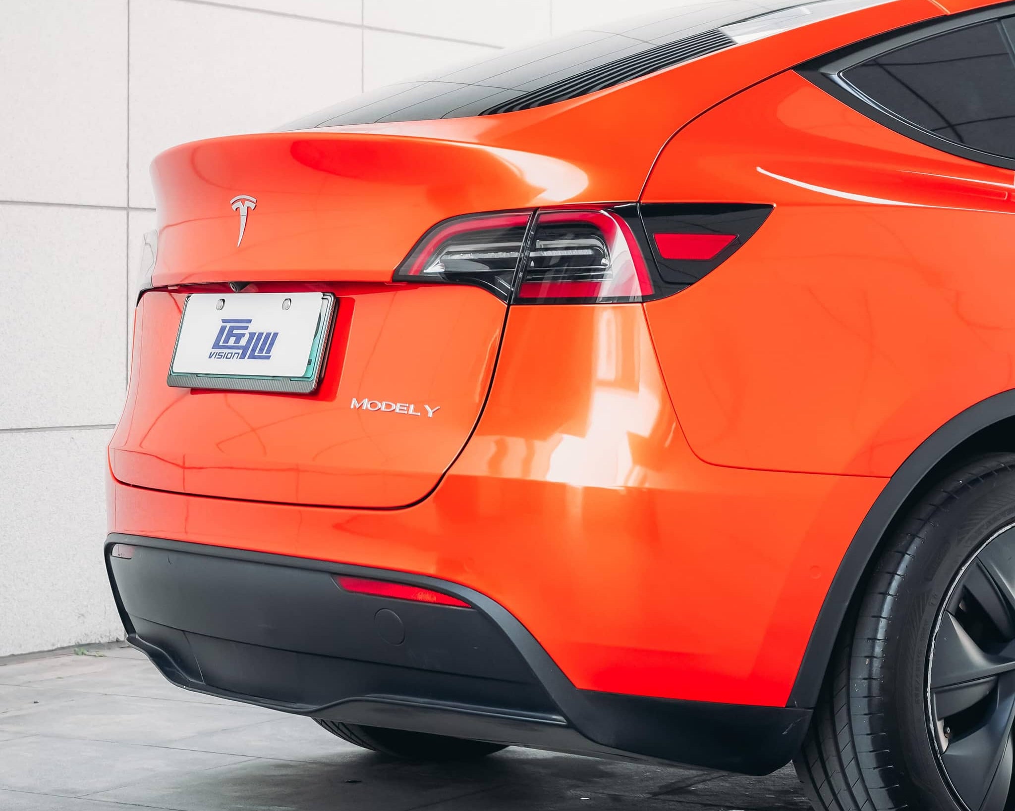 Orange Tesla Model Y with sleek finish using Pre-cut Tesla Wrap Kit by WrapBug