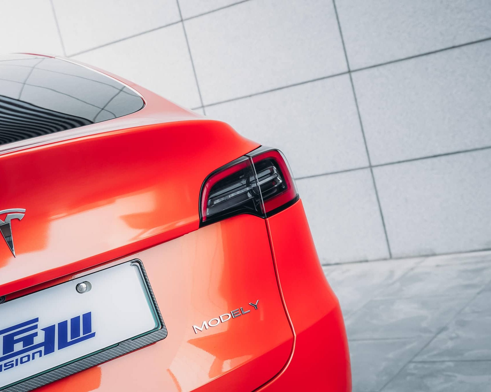 WrapBug Pre-cut Tesla Wrap Kit applied on rear of red Tesla Model Y with glossy finish