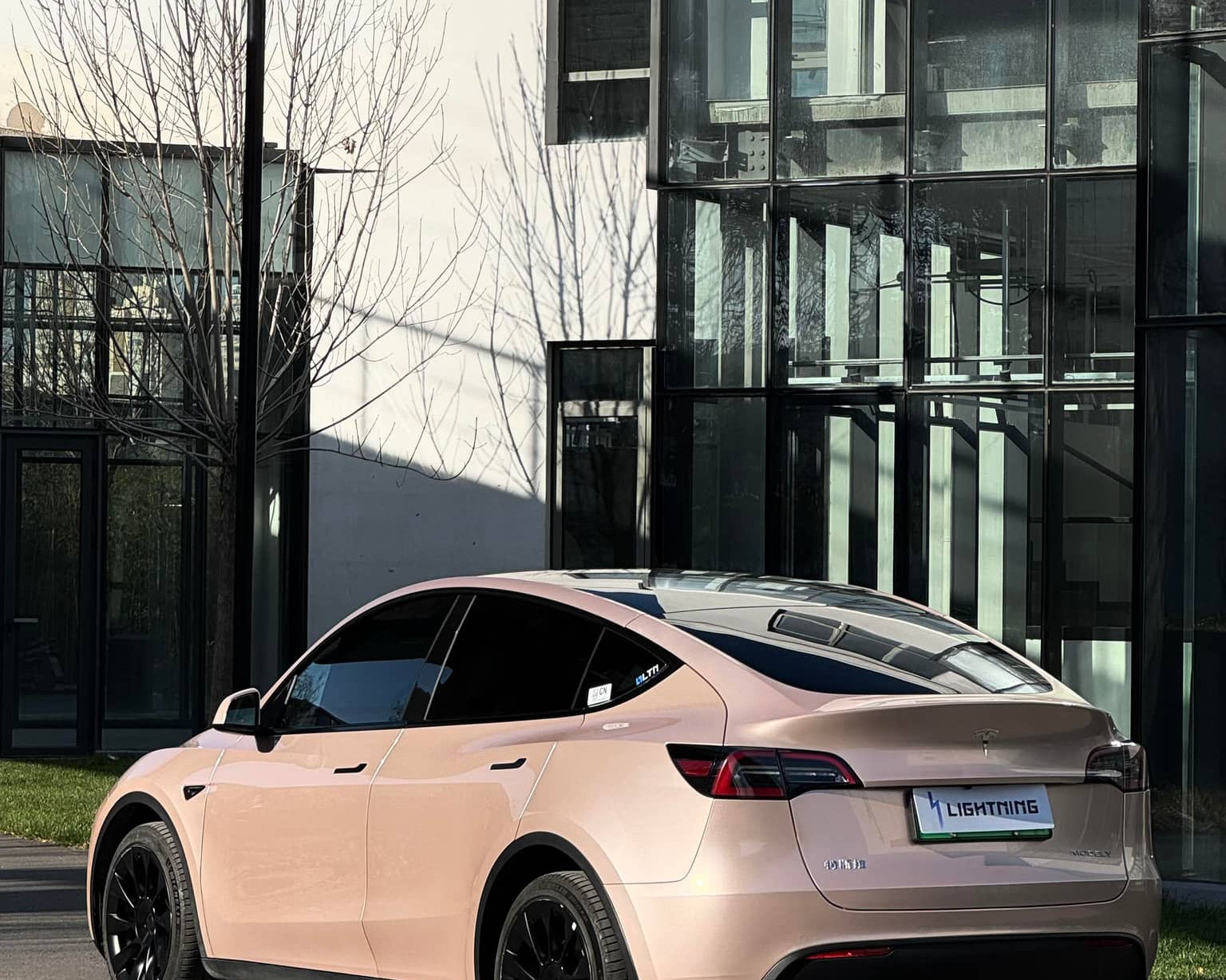 Tesla model Y with a pink matte finish applied using a Pre-cut Tesla Wrap Kit by WrapBug