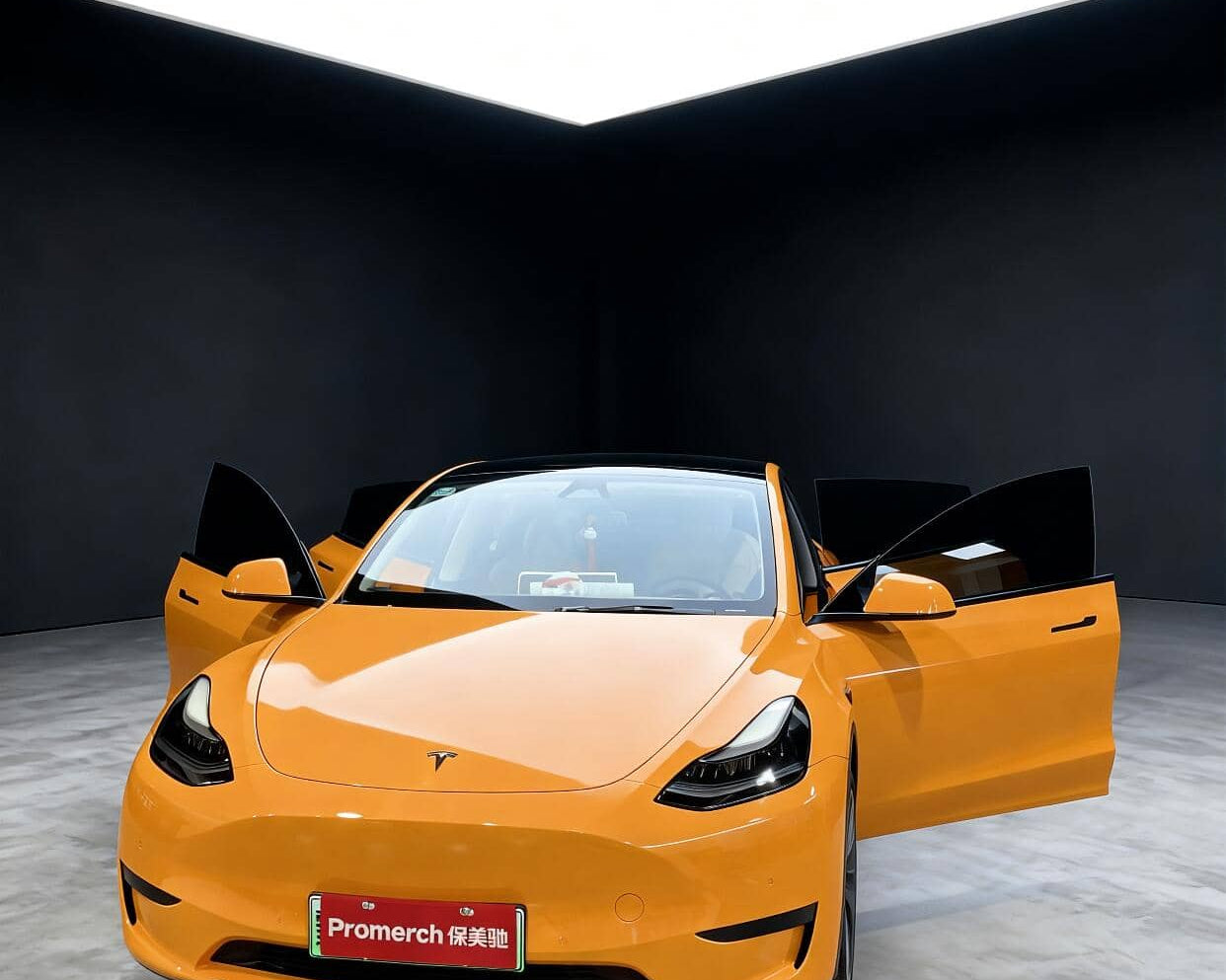 Yellow Tesla Model Y with doors open showcasing Pre-cut Tesla Wrap Kit by WrapBug