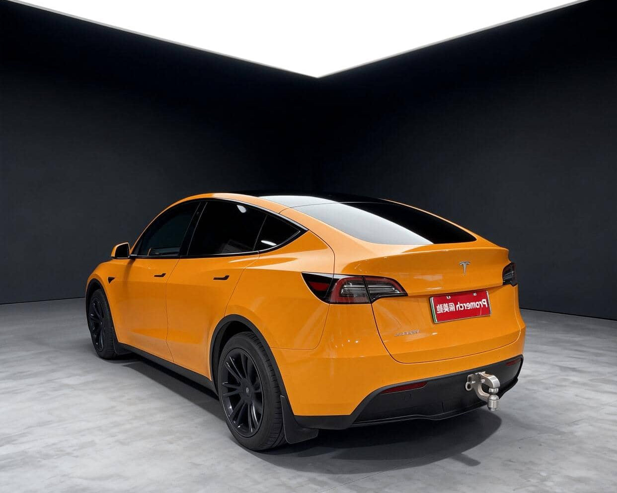 Orange Tesla Model Y featuring a Pre-cut Tesla Wrap Kit by WrapBug in a studio setting