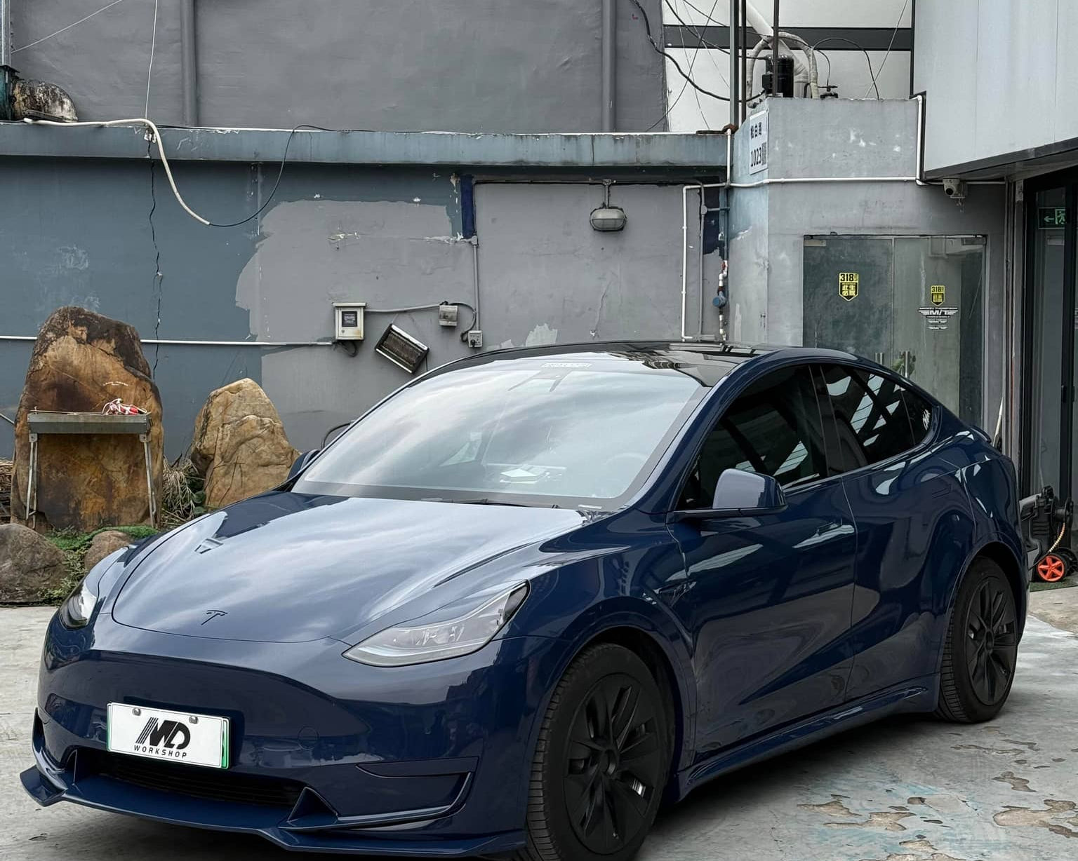 Blue Tesla Model 3 wrapped with Pre-cut Tesla Vinyl Wrap Kit parked in an urban outdoor setting