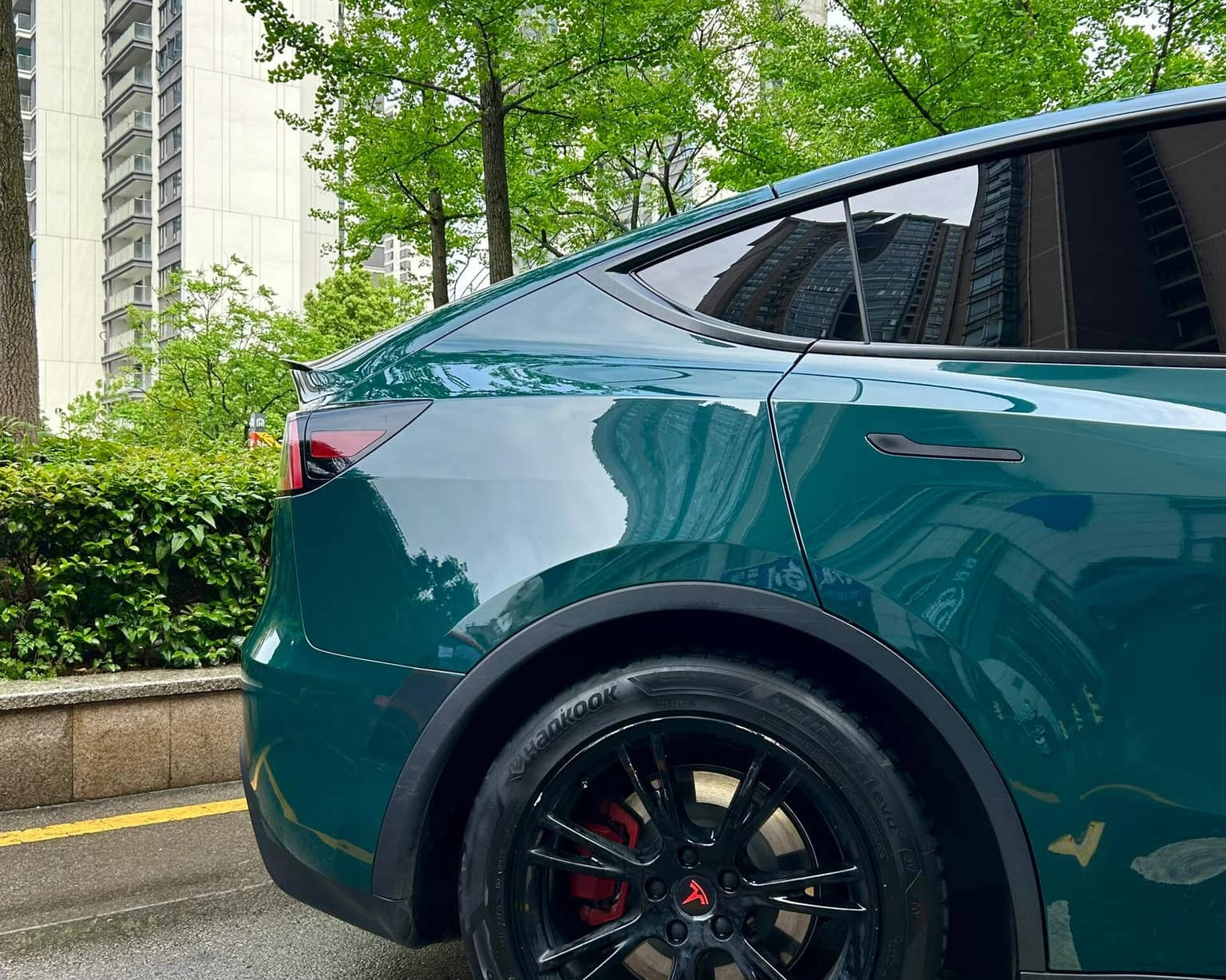 Tesla Model Y rear side wrapped with WrapBug Pre-cut Tesla Vinyl Wrap Kit in glossy green finish