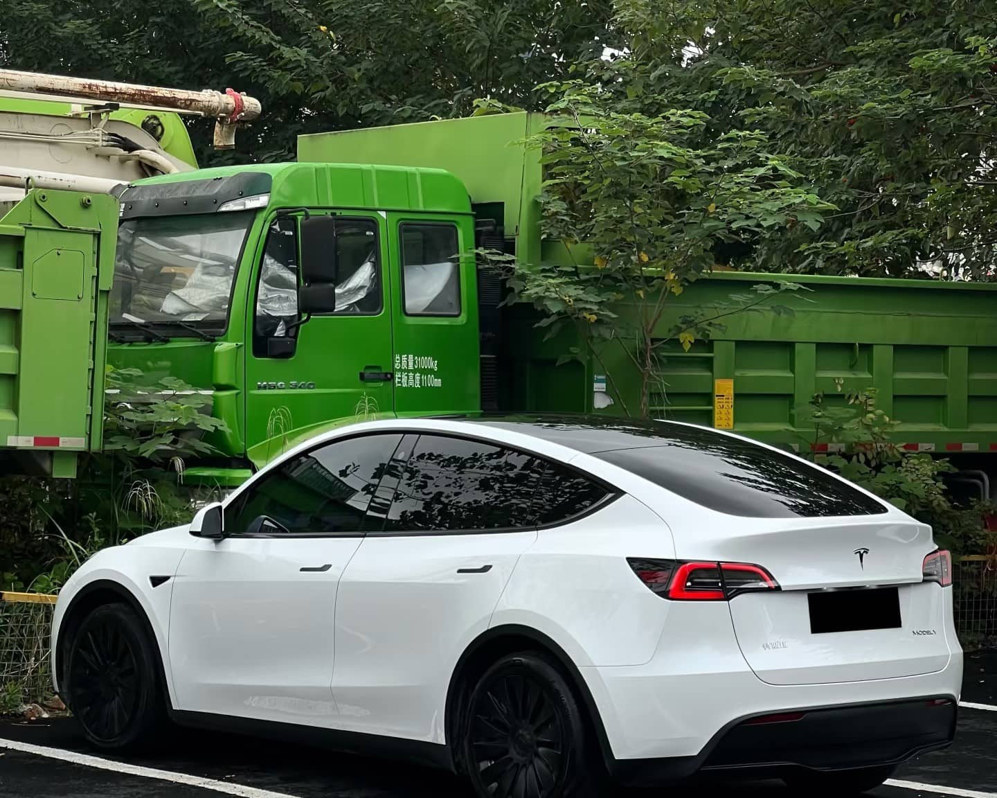 White Tesla Model Y parked outdoors showcasing smooth finish suitable for Pre-cut Tesla Wrap Kit application