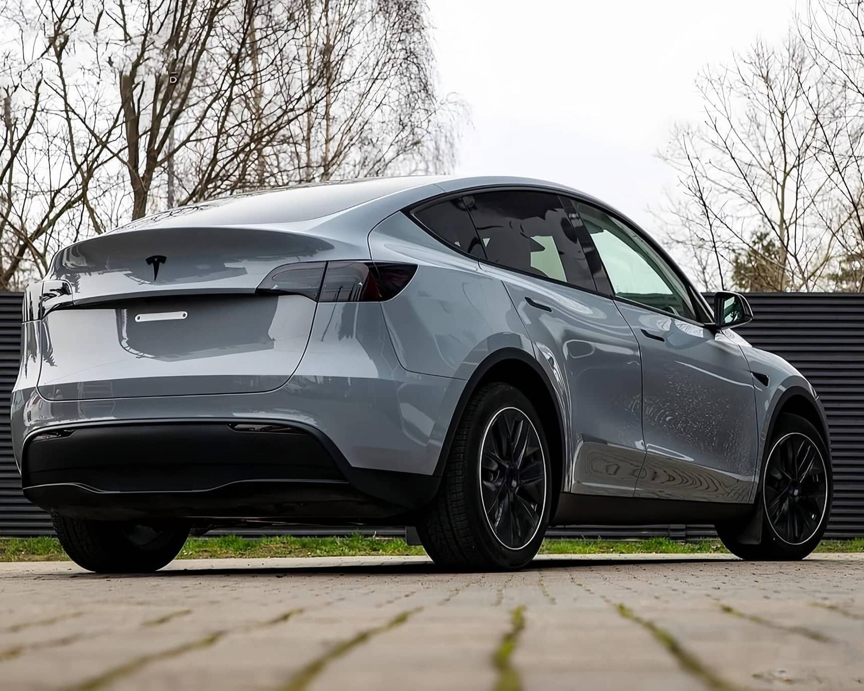 WrapBug matte gray Tesla Model Y electric SUV with black wheels parked outdoors