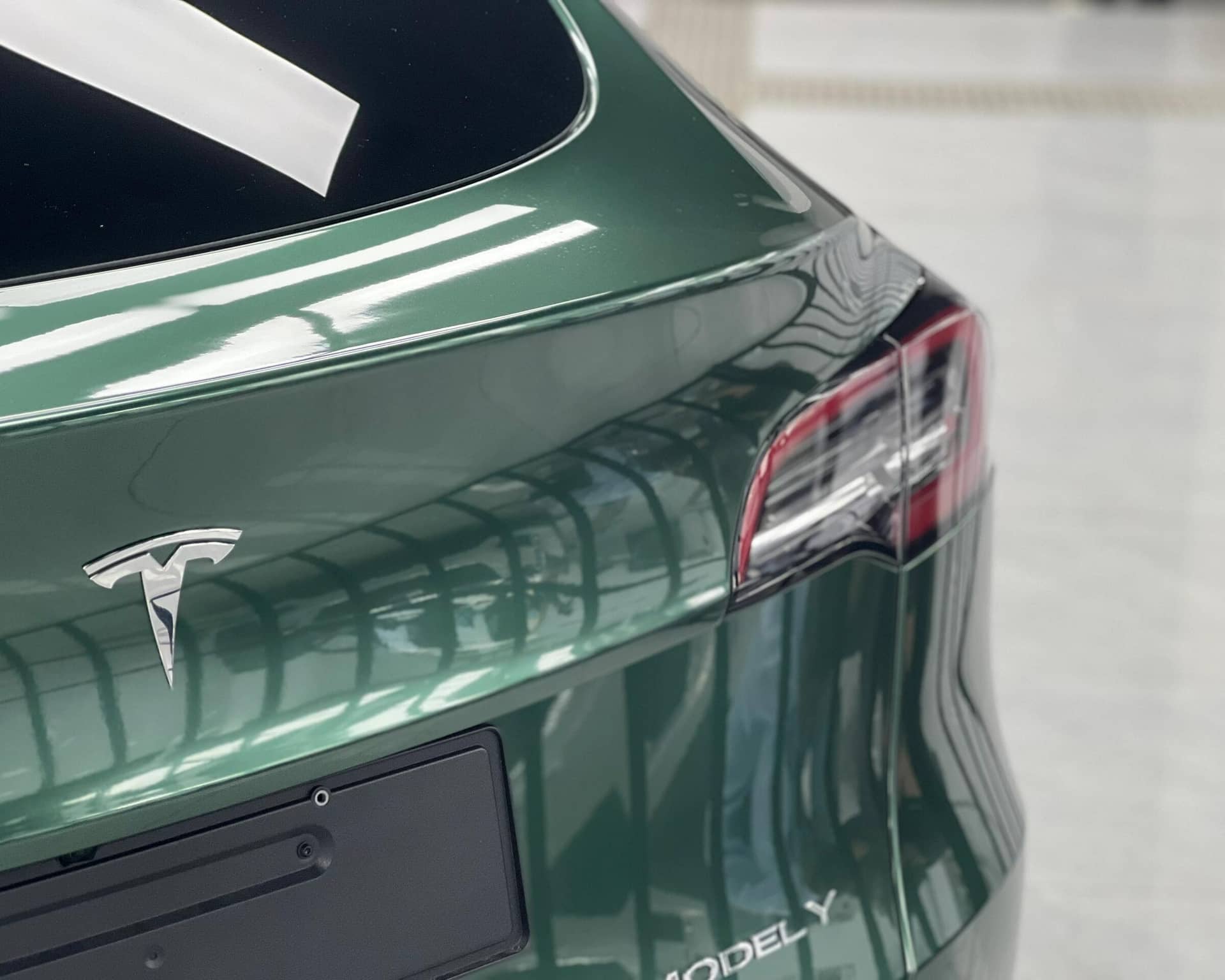 WrapBug pre-cut Tesla wrap kit applied to rear of green Tesla Model Y for smooth finish