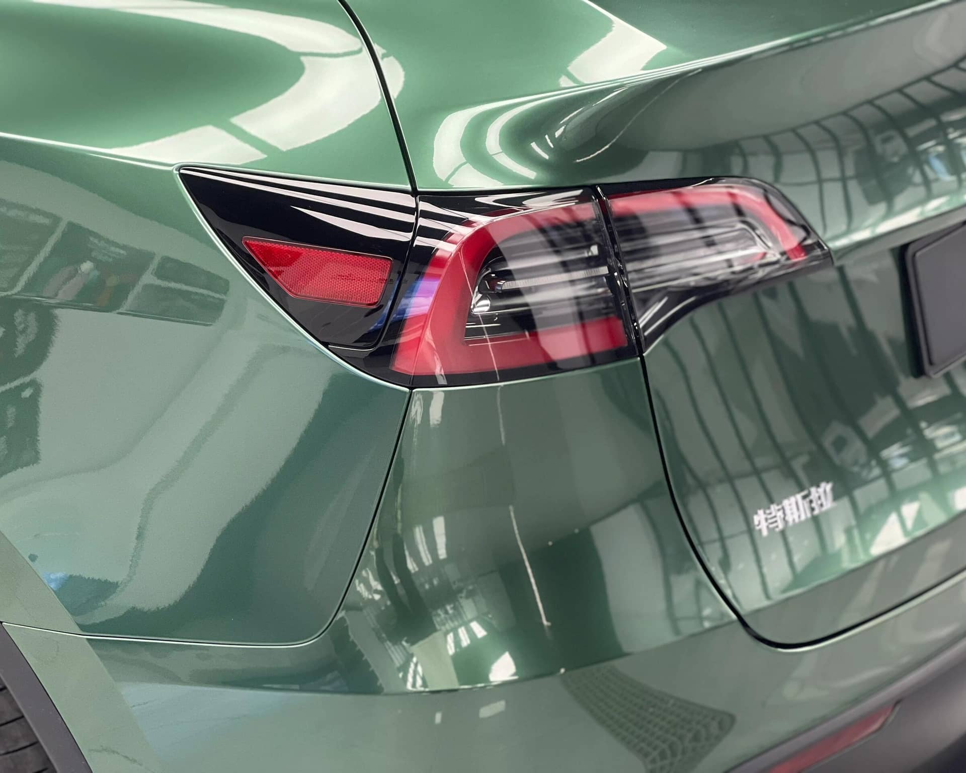WrapBug Pre-cut Tesla Wrap Kit applied on green Tesla rear tail light and body panel