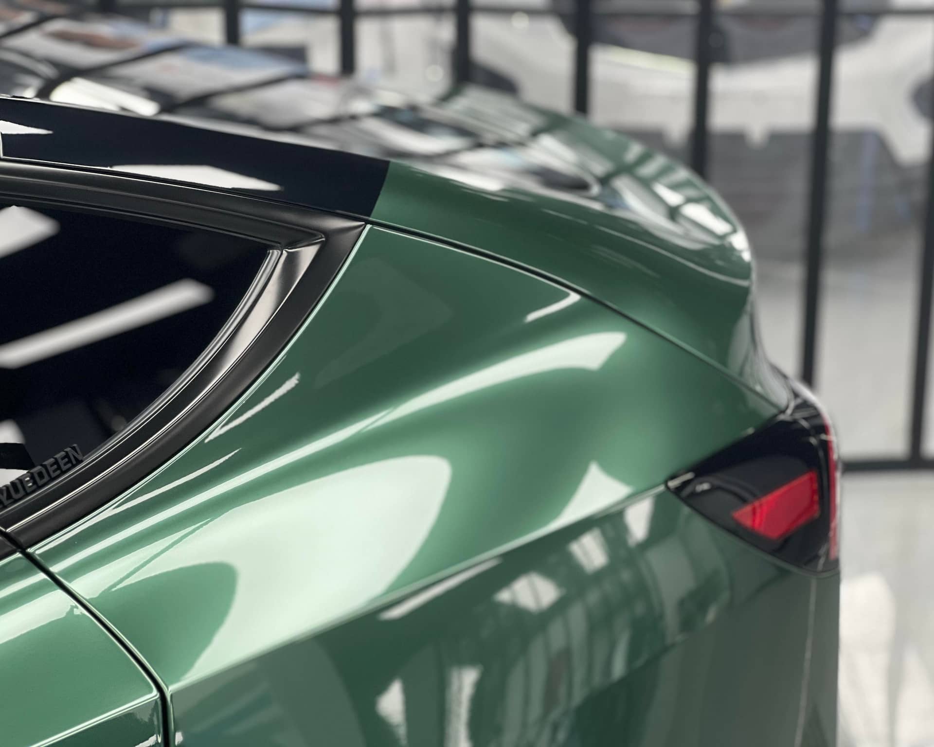 Glossy green Pre-cut Tesla Wrap Kit applied to rear side panel and window frame of Tesla car