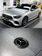 WrapBug pre-cut Tesla vinyl wrap kit applied on silver Mercedes car in showroom with glossy finish