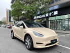 Tesla Model Y wrapped in matte MATTE SPACE GRAY tesla wrap by WrapBug parked on urban street