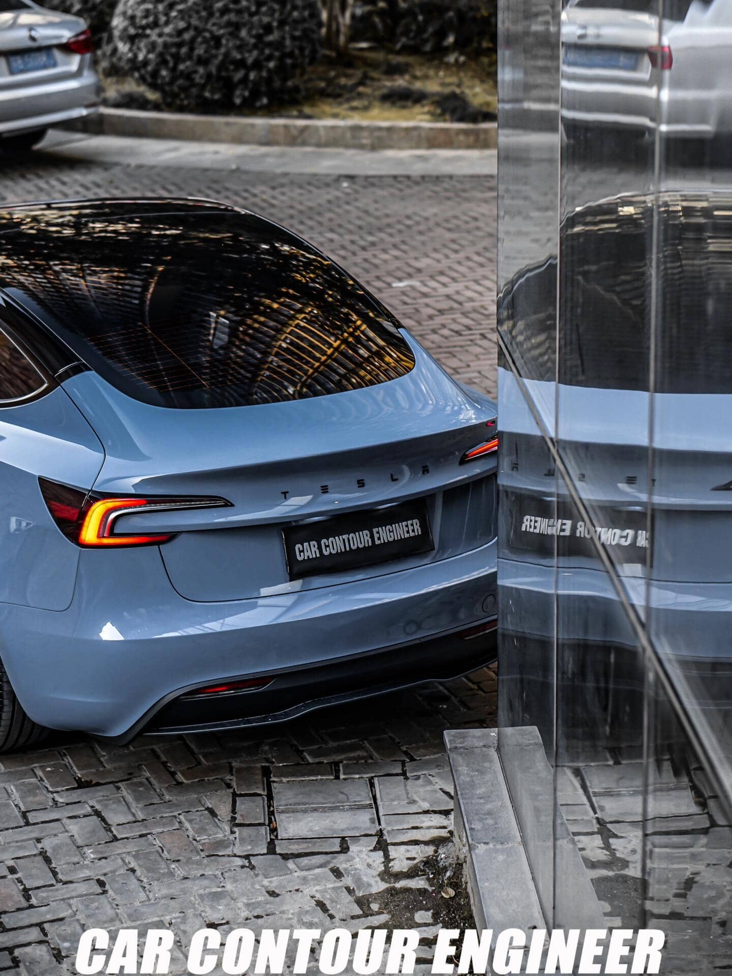 Rear view of blue Tesla wrapped with a glossy Pre-cut Tesla Vinyl Wrap Kit by WrapBug