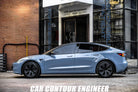 Light blue Tesla Model 3 parked outside shop featuring WrapBug Pre-cut Tesla Vinyl Wrap Kit