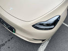 Front corner of Tesla car with matte MATTE SPACE GRAY tesla wrap showing headlight and hood details