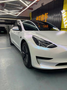 Tesla Model 3 featuring a matte white tesla wrap by WrapBug in a showroom setting