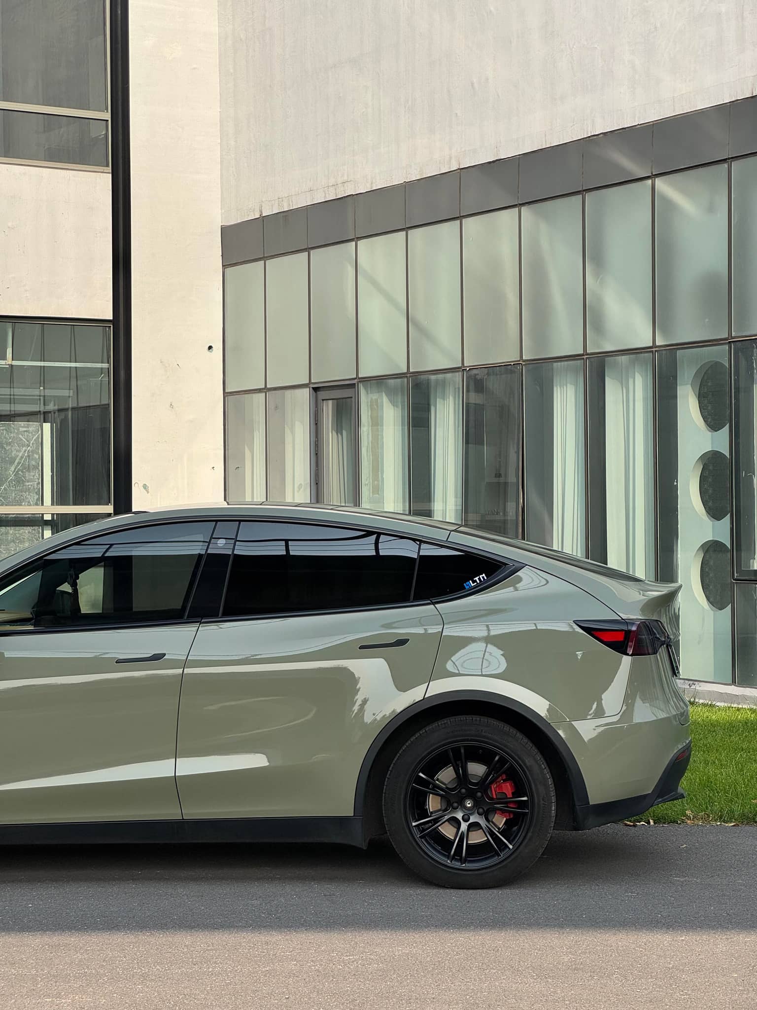 Taupe Tesla Model Y with black wheels featuring WrapBug Pre-cut Tesla Vinyl Wrap Kit exterior