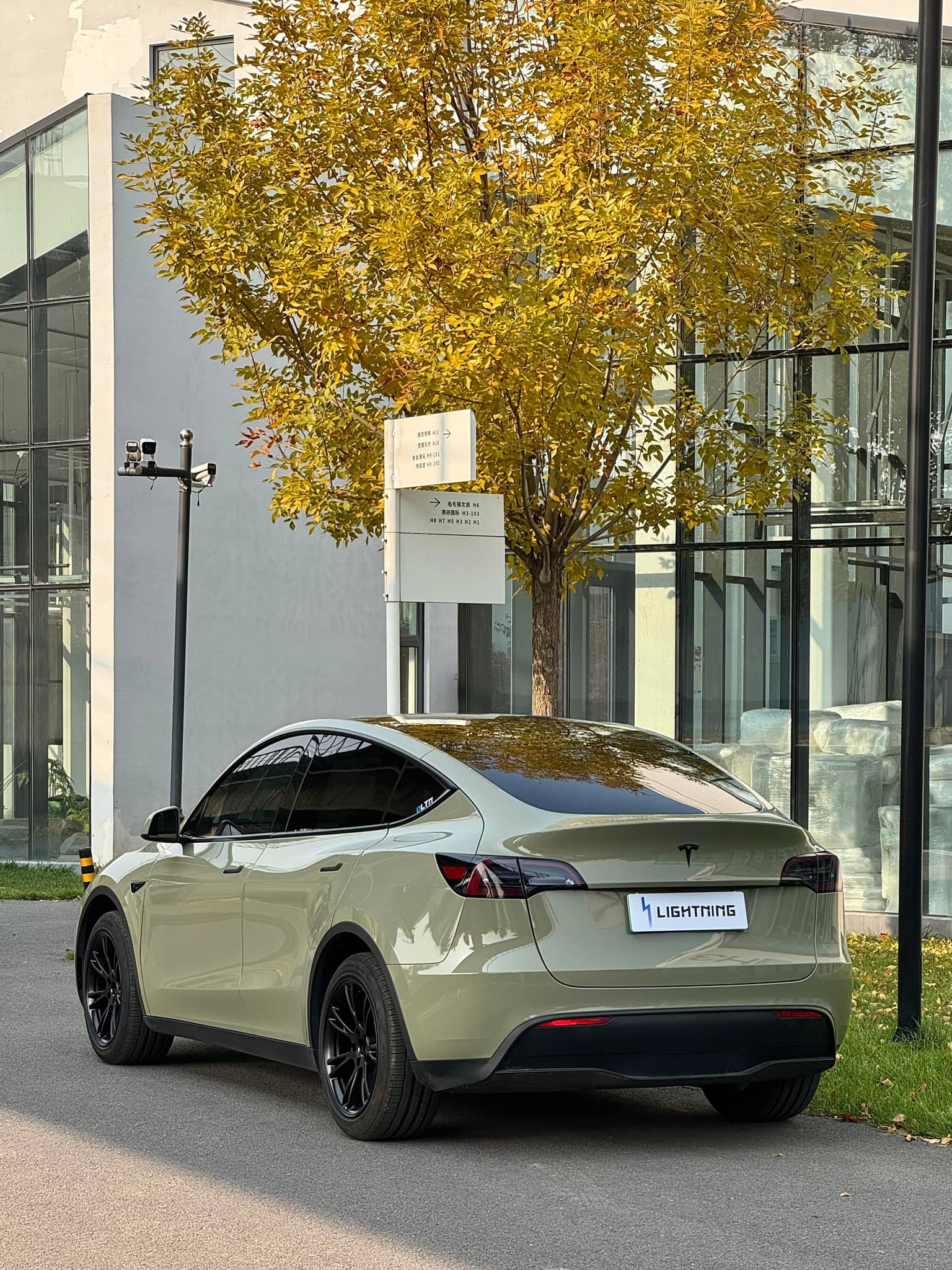 Tesla electric car wrapped in matte olive green using Pre-cut Tesla Vinyl Wrap Kit by WrapBug