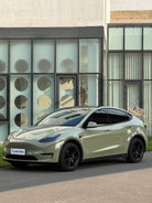 Tesla car wrapped with Pre-cut Tesla Vinyl Wrap Kit by WrapBug in matte green color parked outdoors
