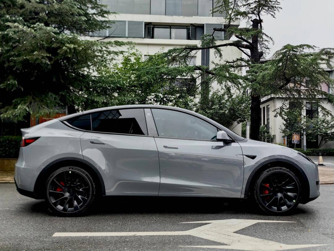 Silver Tesla Model Y wrapped with a Pre-cut Tesla Vinyl Wrap Kit parked on the street