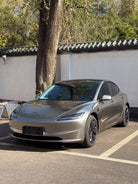 Silver Tesla Model 3 parked outdoors featuring WrapBug pre-cut Tesla wrap kit applied