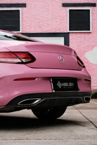 Pink luxury car rear view wrapped with Pre-cut Tesla Wrap Kit by WrapBug in an urban setting