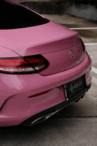 WrapBug Pre-cut Tesla Wrap Kit applied on the rear of a pink luxury car in an outdoor setting