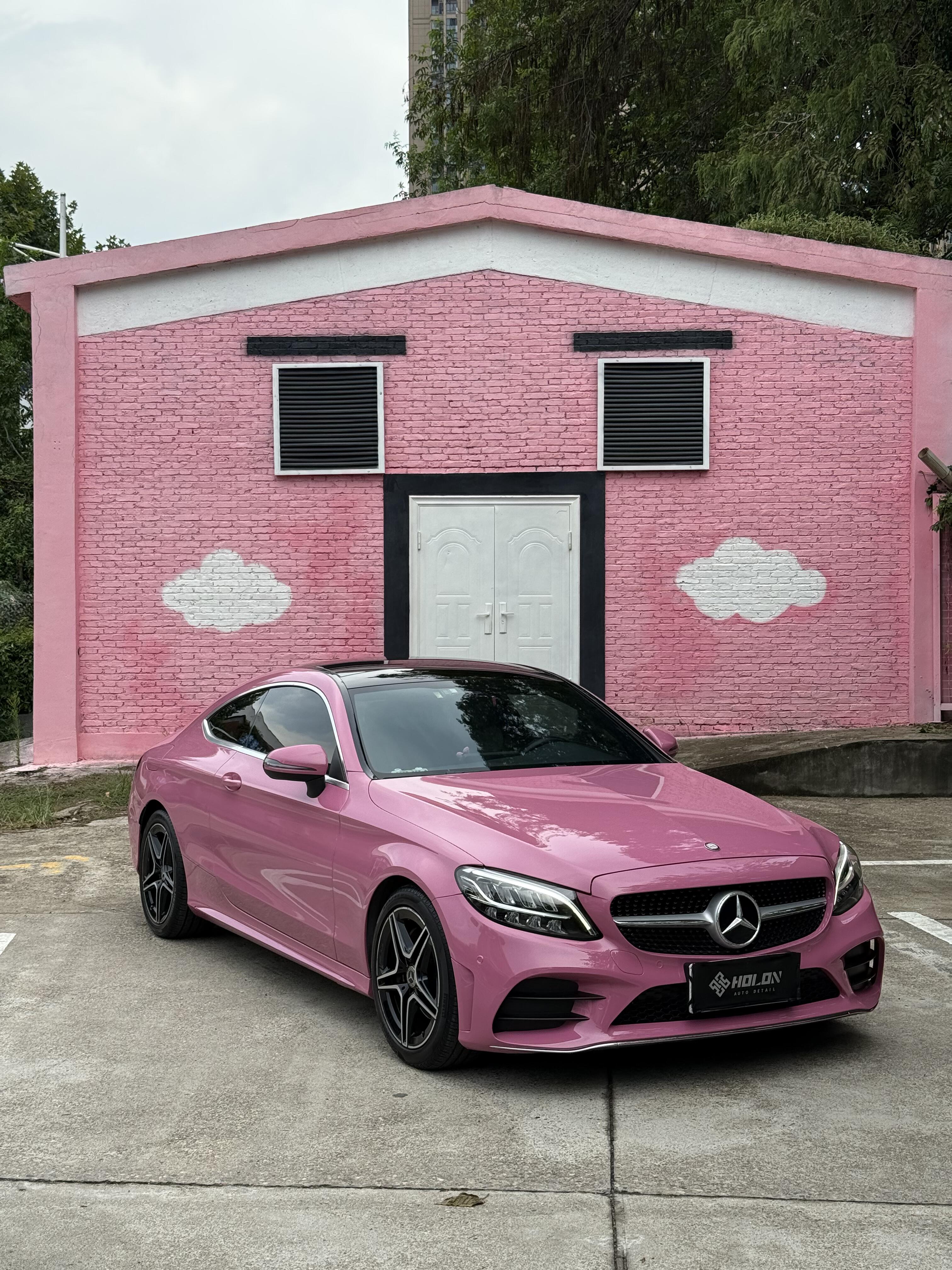 Pink Mercedes parked in front of pink house wall showcasing Pre-cut Tesla Wrap Kit by WrapBug
