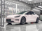 White Tesla Model 3 wrapped with a Pre-cut Tesla Wrap Kit by WrapBug in a showroom