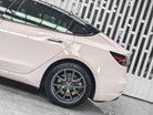 WrapBug Pre-cut Tesla Wrap Kit applied on rear side of white Tesla Model 3 with black roof and alloy wheels