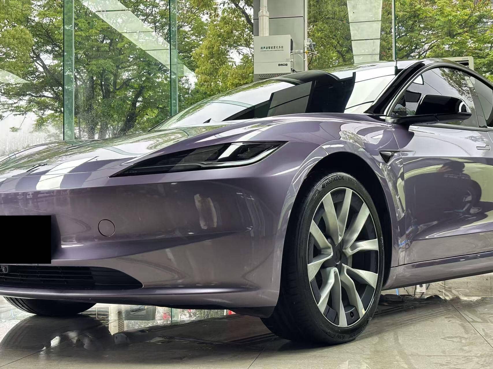 Purple Tesla Model 3 featuring a glossy finish using WrapBug Pre-cut Tesla Wrap Kit for sleek design
