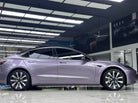 Tesla Model 3 wrapped in purple using WrapBug Pre-cut Tesla Wrap Kit in a showroom