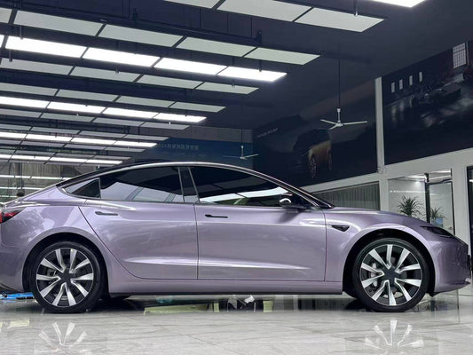 Tesla Model 3 wrapped in purple using WrapBug Pre-cut Tesla Wrap Kit in a showroom