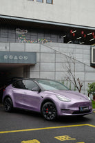 Purple Tesla Model Y parked outdoors with WrapBug Pre-cut Tesla Wrap Kit applied for sleek appearance