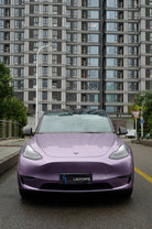 Purple Tesla Model 3 covered with Pre-cut Tesla Wrap Kit parked on urban street with buildings