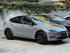 Gray Tesla Model Y parked outdoor showcasing WrapBug tesla color PPF on body and black rims