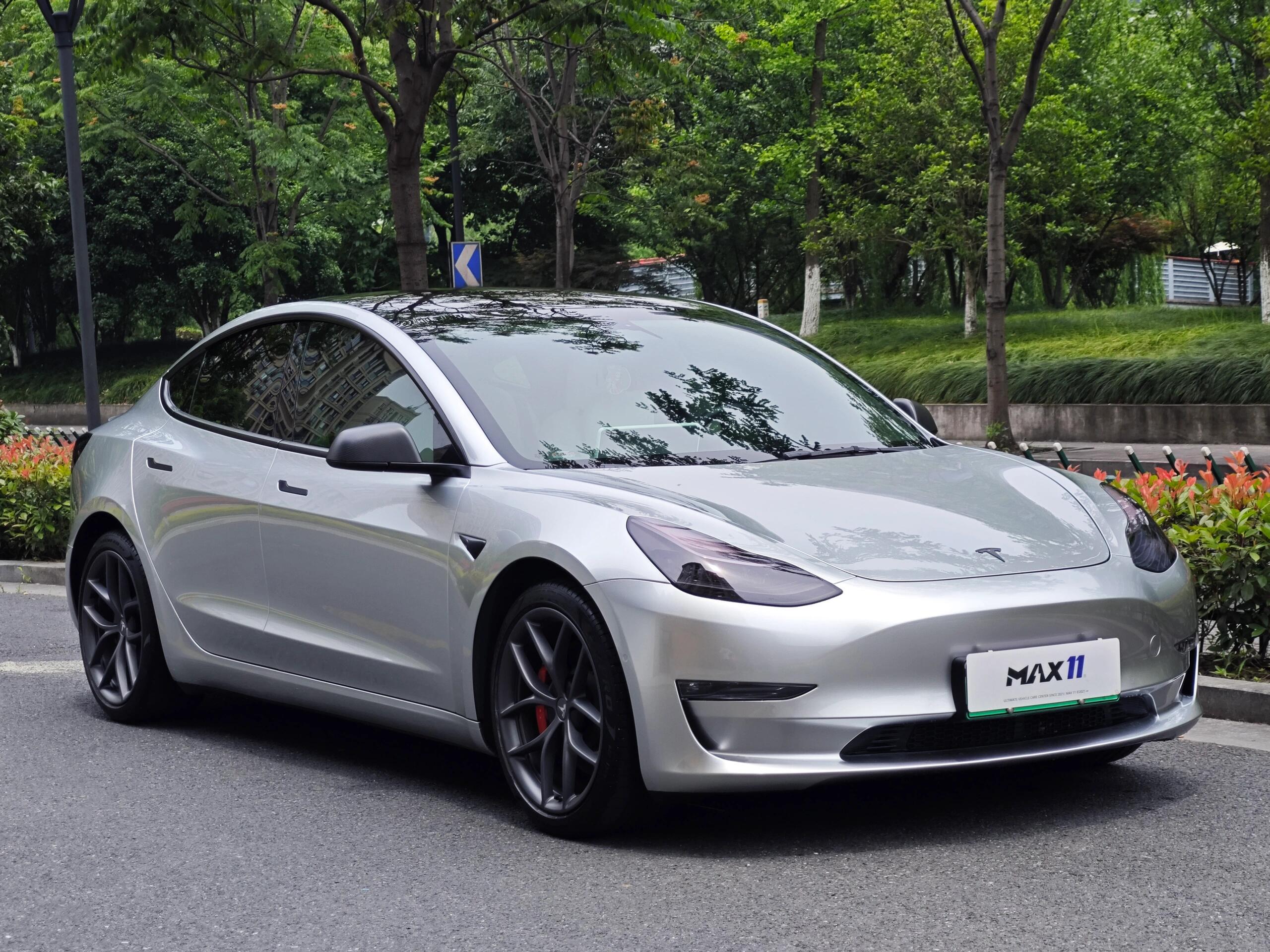 Silver Tesla Model 3 parked on road showcasing smooth finish from Pre-cut Tesla Wrap Kit by WrapBug