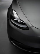 Close-up of a sleek matte gray car front headlight showcasing modern automotive design